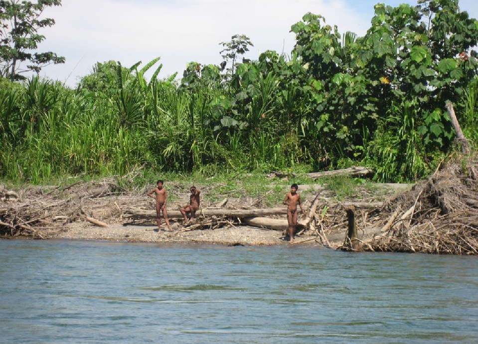 Mashco-Piro tribe members near a river in the Peruvian jungle.