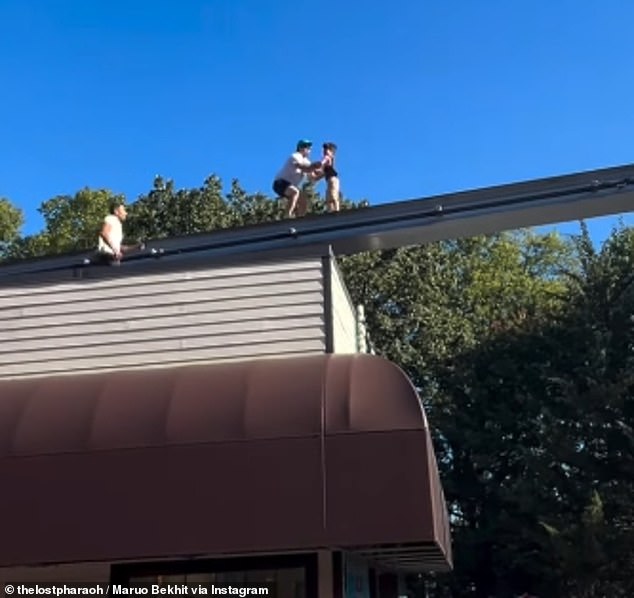 Sampson climbed on the roof of a food stand, jumped onto the tracks, grabbed the boy and then carried the boy down to safety