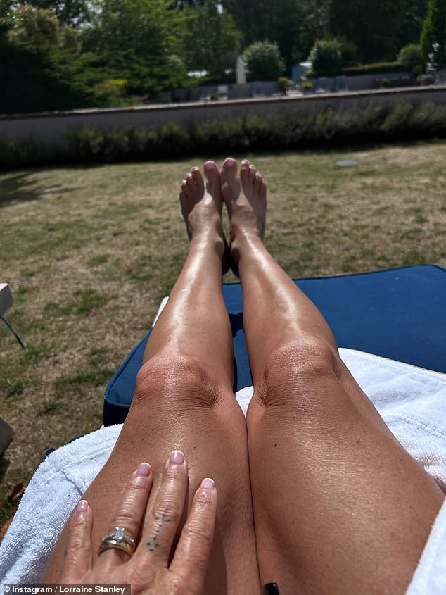 While she also couldn't resist showing off her sparkling diamond ring and new wedding band as she sunbathed in the garden