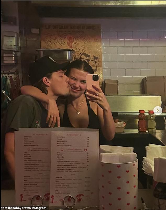 Here she gets a kiss from her husband while in a restaurant
