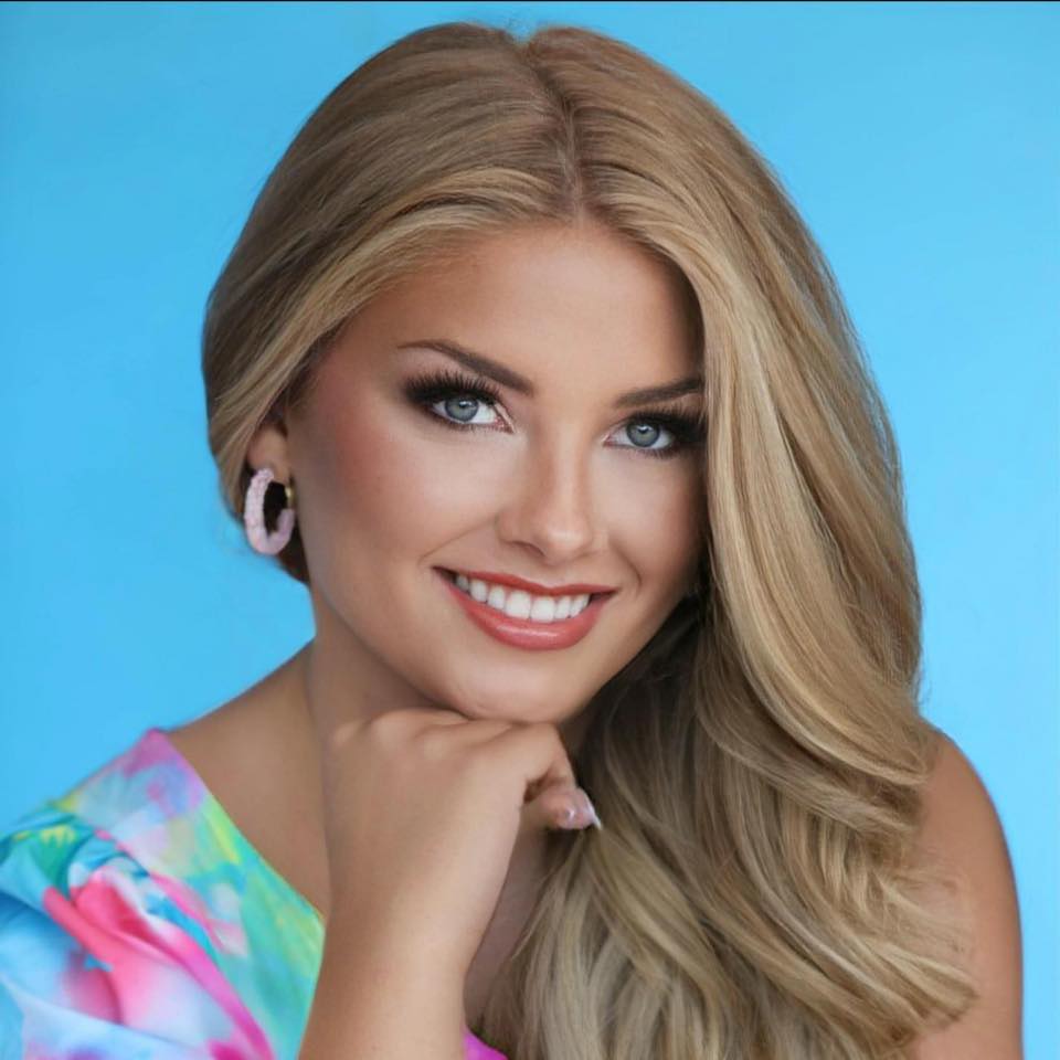 Portrait of a young woman with blonde hair.