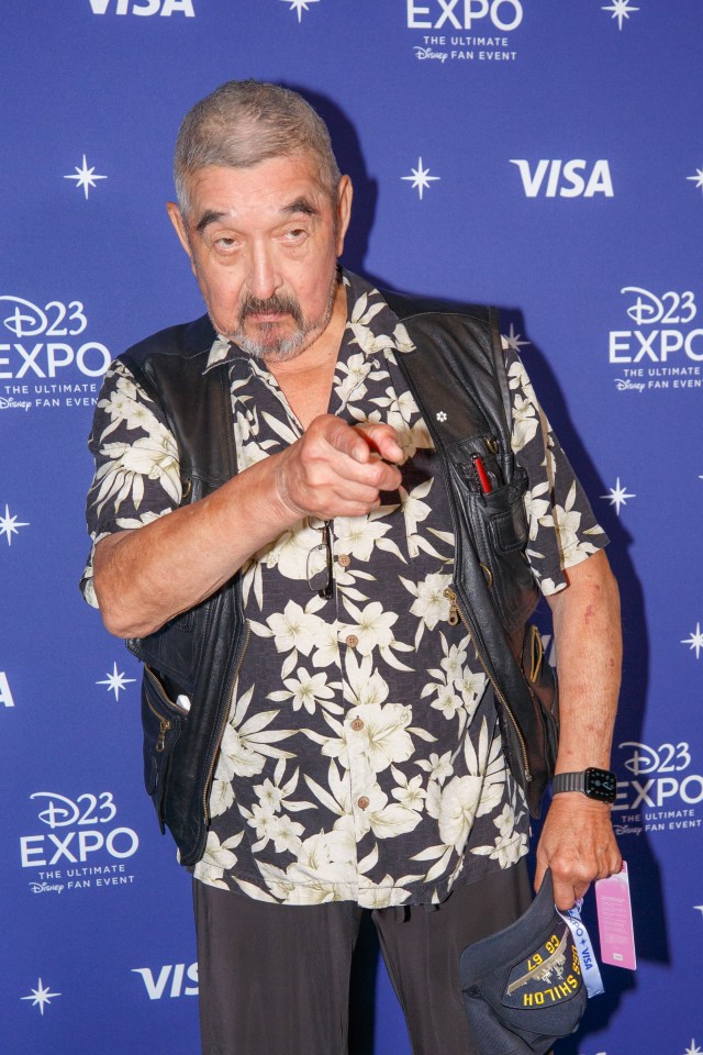 A man at the D23 Expo points at the camera.