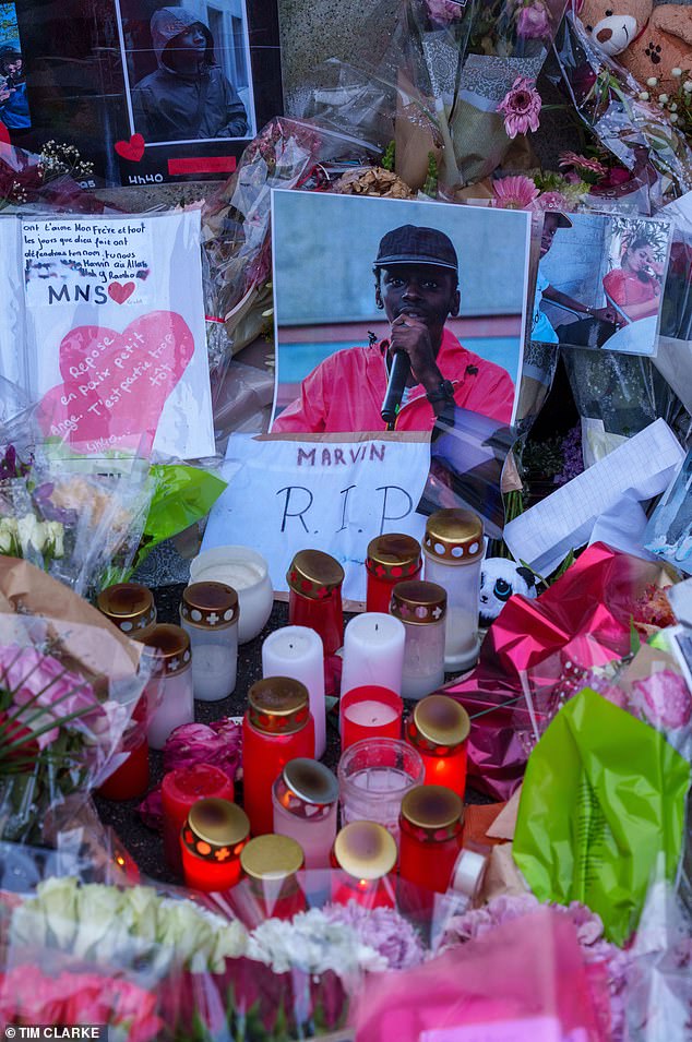 Dozens of flowers, candles, letters and pictures of Marvin have gathered in the spot where he died