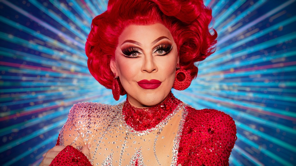 Portrait of a drag queen in a red sequined outfit.