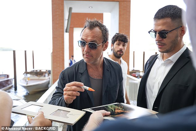 As Jude made his way up the dock, he was greeted by fans and happily stopped to sign autographs as they asked if he was OK after the accident
