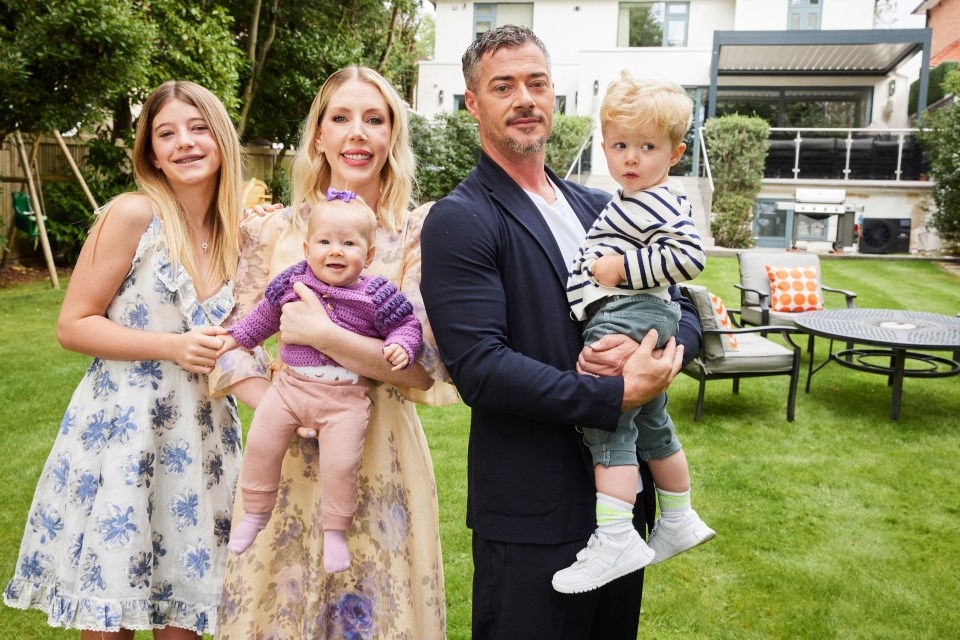 Katherine Ryan with her husband and three children in their garden.