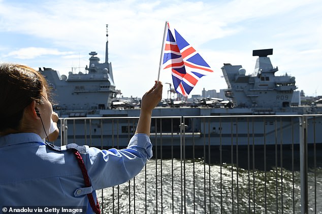 The ship was given a warm send off from locals in Tokyo, who came out waving the Union flag