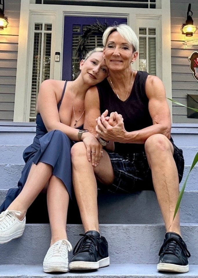 Photo of a couple sitting on steps, embracing.