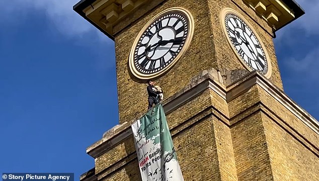 He tightly clutched onto his dog at the top of the tower, 120ft above the ground of commuters below
