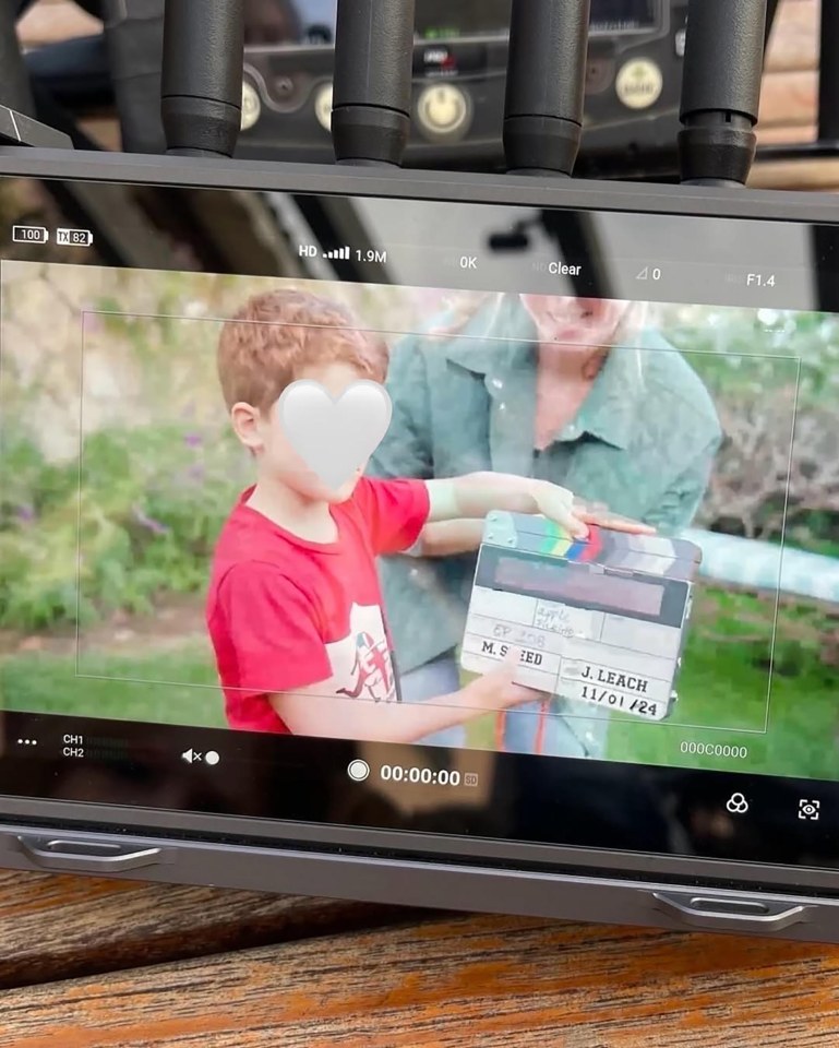 Behind-the-scenes image from the set of "With Love, Meghan," showing a child holding a clapperboard.