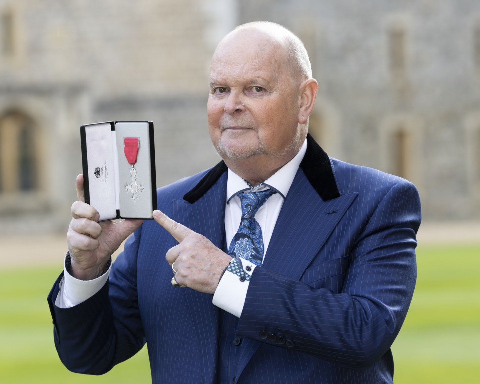 James Whale displaying his MBE at Windsor Castle.