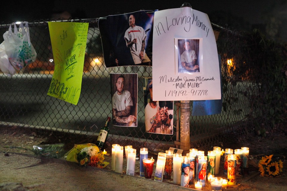 Makeshift memorial to Mac Miller with candles and photos.