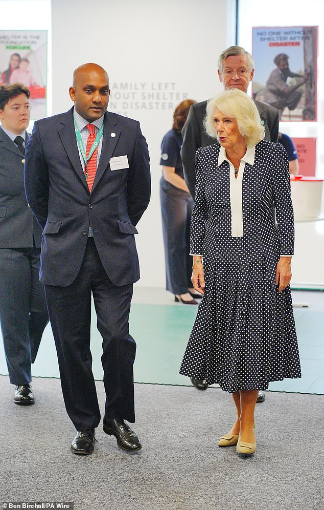 Queen Camilla is given a tour by the Chief Executive Officer of ShelterBox, Sanj Srikanthan
