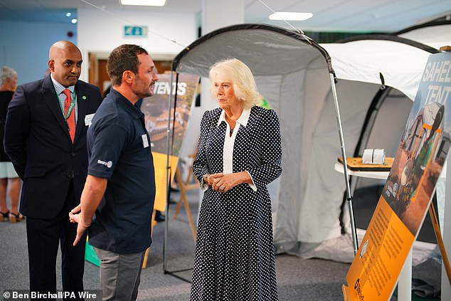 Queen Camilla is given a tour by the Chief Executive Officer of ShelterBox, Sanj Srikanthan (left), during a visit to the headquarters of the charity