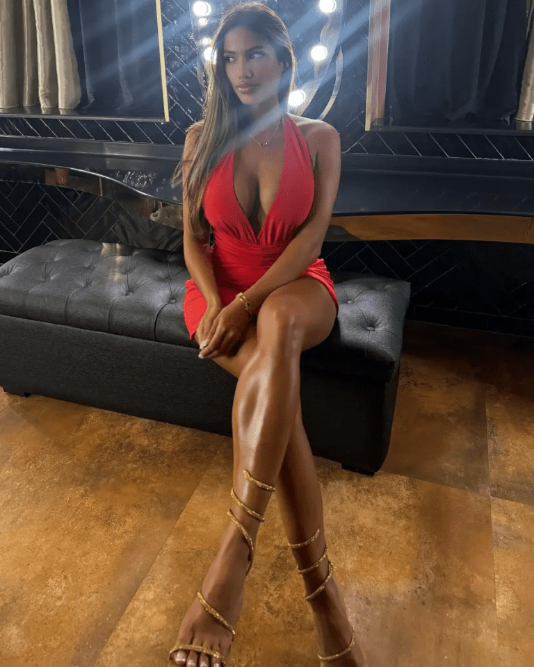 Woman in red dress and gold sandals.