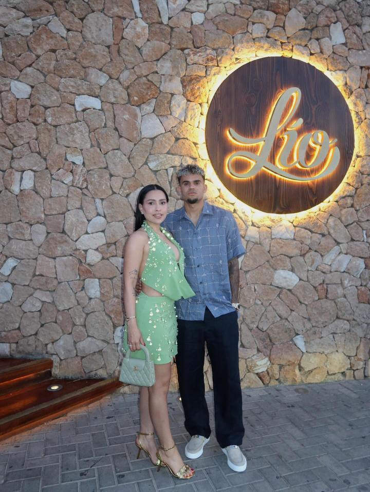 Couple posing in front of Lio restaurant.