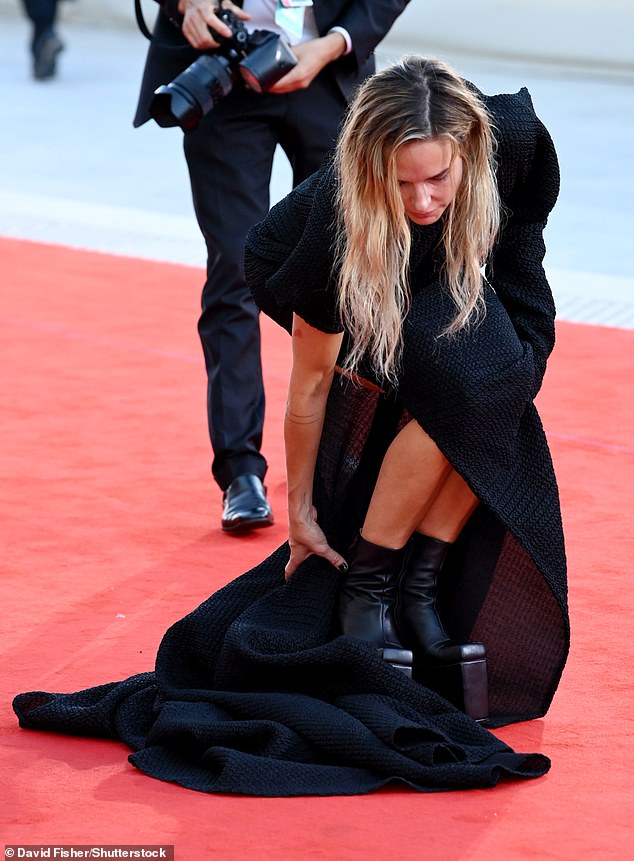 She was spotted getting her dress in the perfect position, and flashed a glimpse at her quirky platform ankle boots