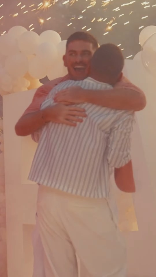 Adam Frisby and Jamie Corbett embracing.