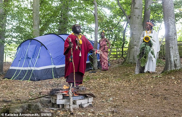 Pictured is the tribe and their woodland encampment, which has reportedly left locals angry