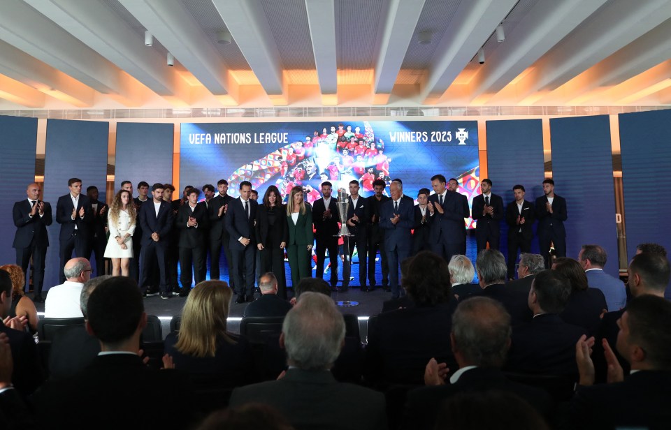 Portugal's President Marcelo Rebelo de Sousa, the Portuguese Football Federation President, the Prime Minister, Cristiano Ronaldo, the Portugal football team, and Diogo Jota's wife with the UEFA Nations League trophy.