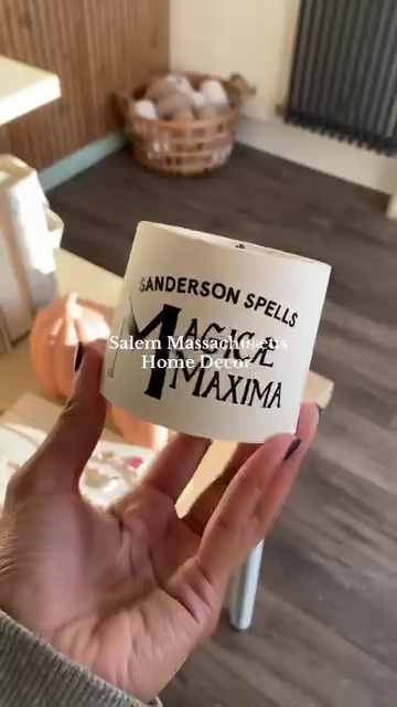 Hand holding Sanderson Spells candle.