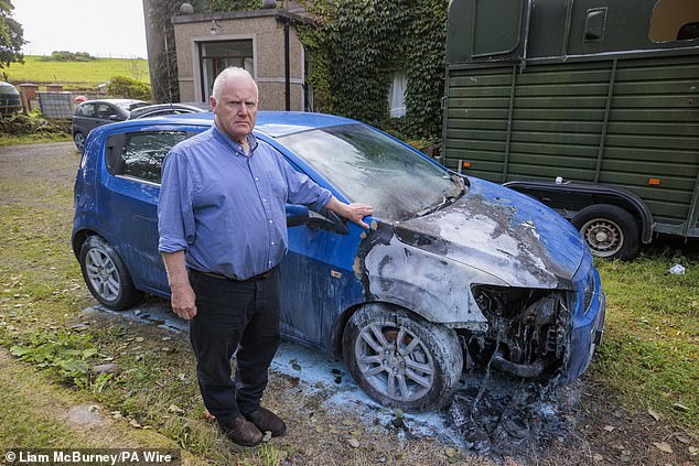 Sam Carson (pictured) spoke out after a number of cars were set on fire in the Co Antrim town on Sunday and destroyed, in a racist attack. Police have appealed for information