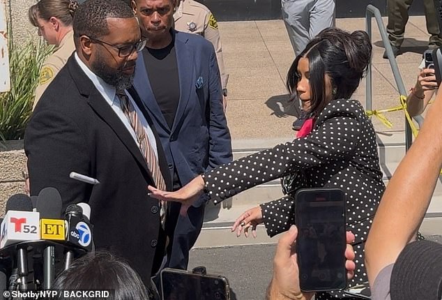 Cardi was dressed in a stylish ensemble including a monochrome polka dot trouser suit