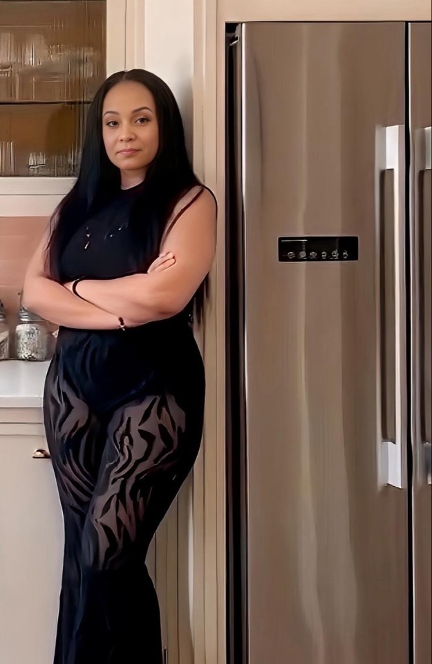 Woman in black outfit standing in a kitchen.