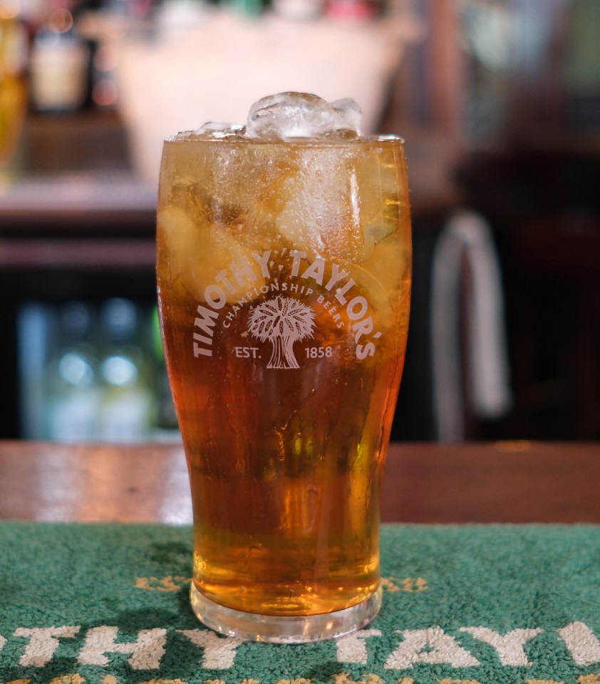 A pint of Timothy Taylor's beer with ice.