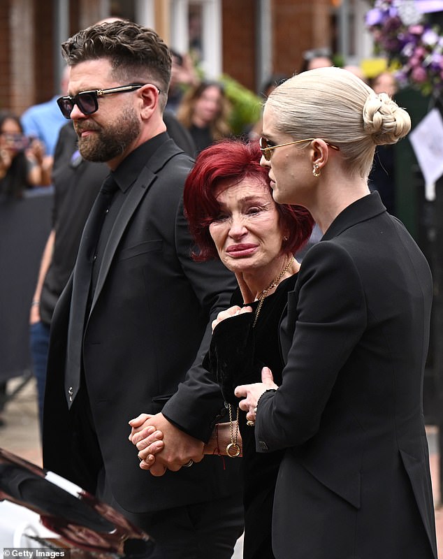 Thousands took to the streets to pay their respects to the rock legend as his devastated family walked behind his coffin (pictured July 22)