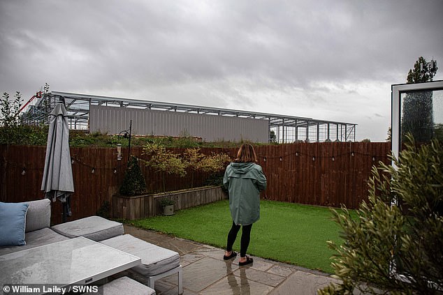 Joanne Gerrard pictured on her terrace just metres from the warehouse. Plans from developer PLP show the enormous complex will eventually host four of these warehouses