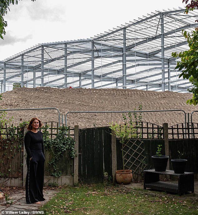 Paula Boardman, pictured, lives with her husband and two kids in a house that backs onto the imposing warehouse