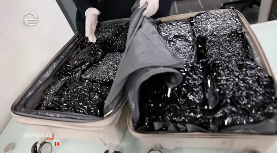Suitcase filled with packages of suspected contraband.