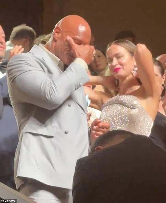 He began his acting career on television while wrestling and during the Venice screening one fan noted his career roots as he shouted: 'Can you smell what the Rock is cooking?!'