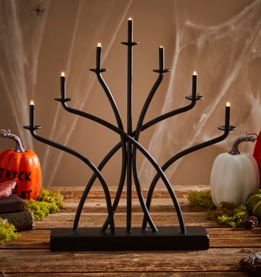 Black metal seven-light candelabra with LED candles.
