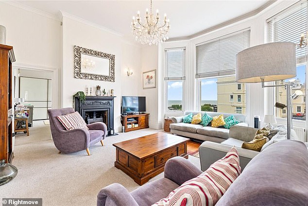 The light and airy apartment's large living room boasts sweeping views of Hove's seafront