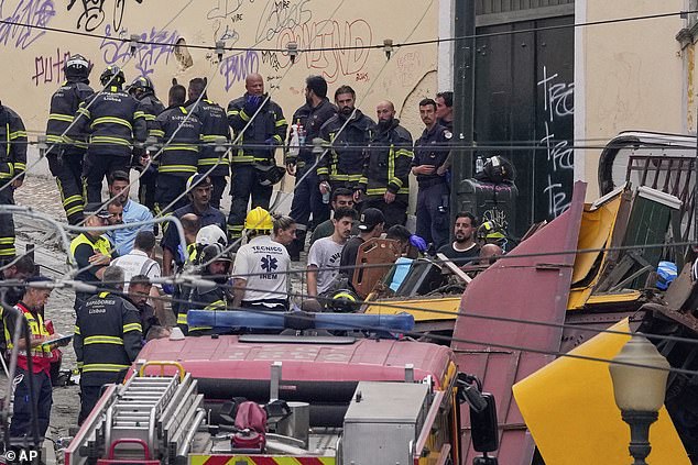 Emergency teams work at the site of a derailed electric streetcar in Lisbon, Portugal, Wednesday