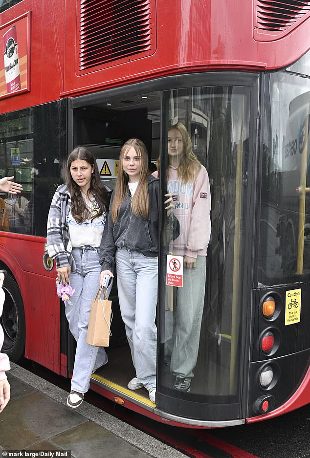 Nastya, 14, Nastia, 14, and Kseniia, 15, getting off a London bus at Tower Bridge