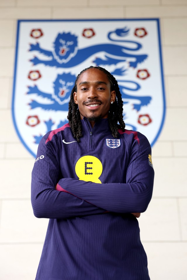 Djed Spence of England poses in a team tracksuit.