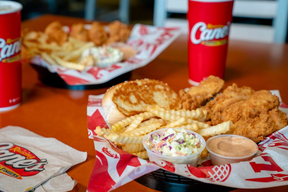 Raising Cane's chicken fingers, fries, coleslaw, and a bun.