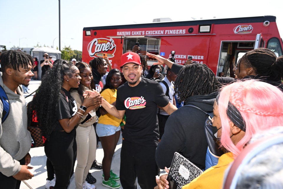 Chance the Rapper greeting fans at a Raising Cane's Chicken Fingers event.