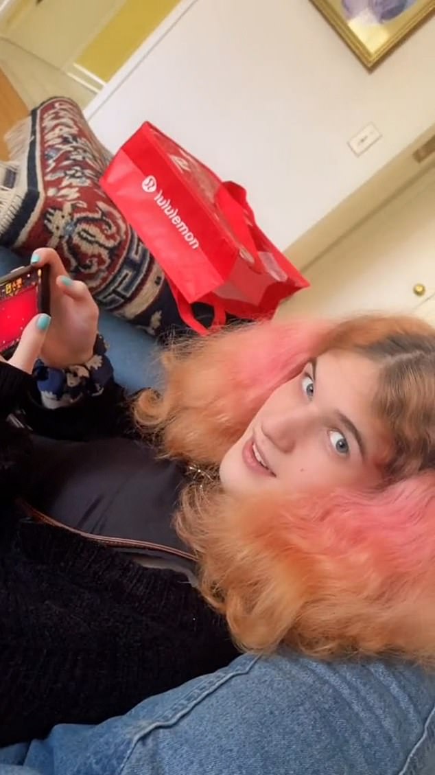 Another clip, set to ominous music, shows the killer with bright pink hair grinning and biting her lip