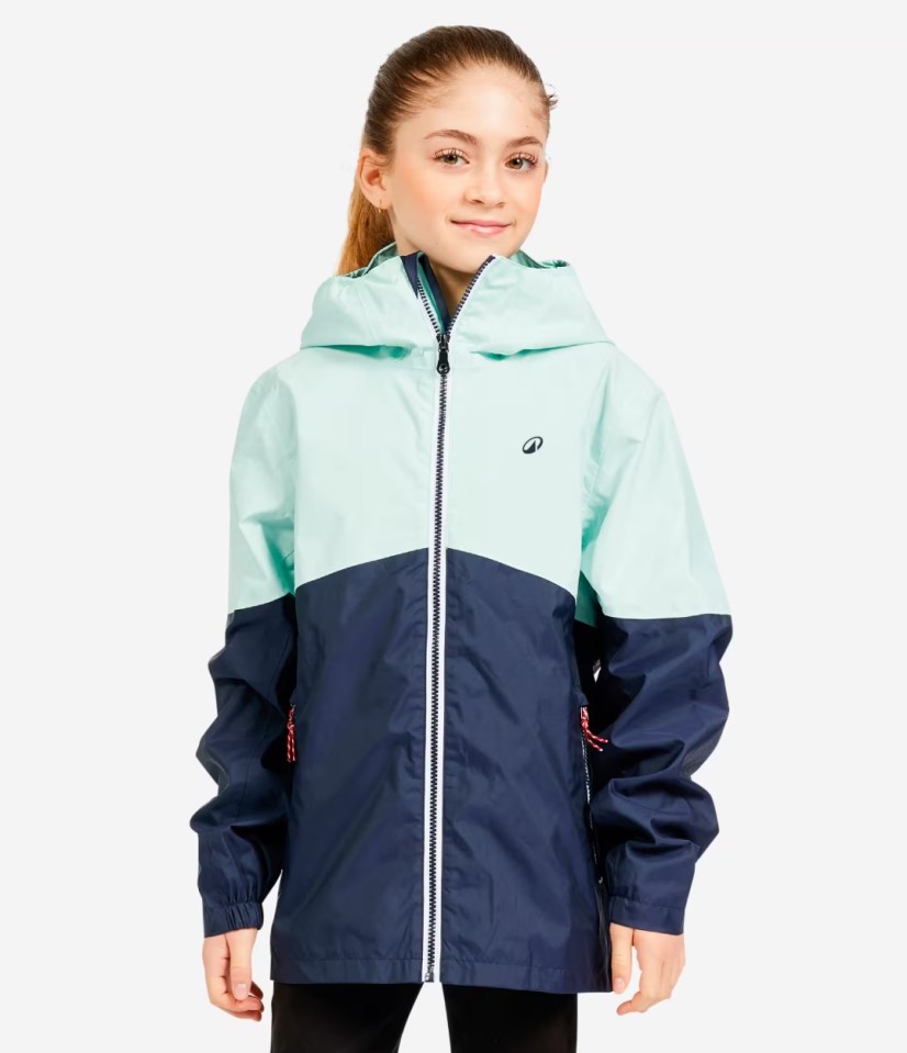 Girl wearing a teal and navy blue rain jacket.
