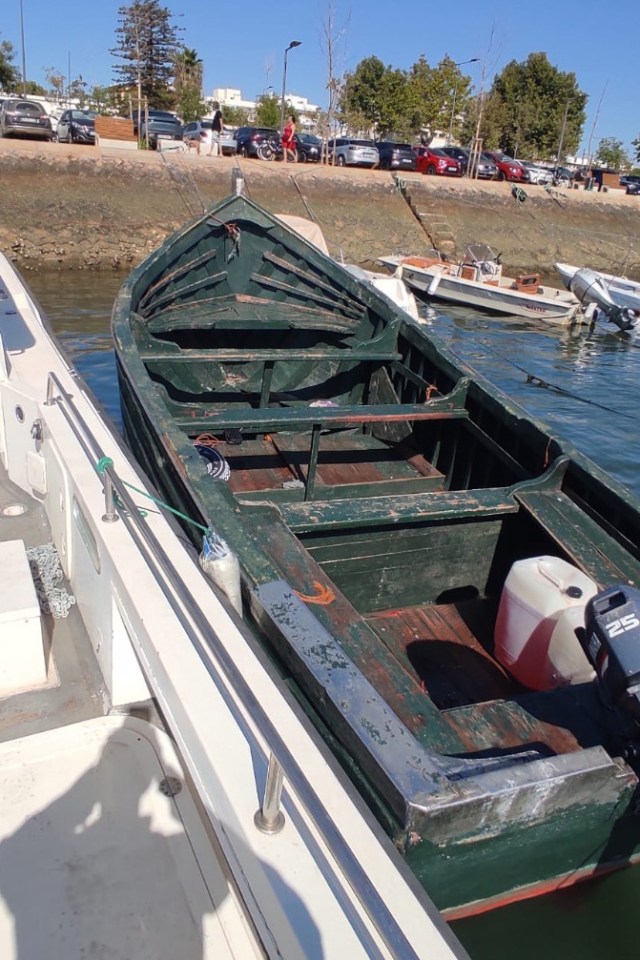 Migrant boat on a beach.