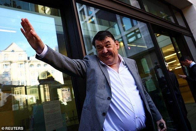 Linehan waves and smiles before he enters magistrates' court for his trial today