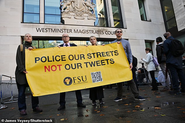 Toby Young and protesters hold up a banner displaying 'Police our streets, not our tweets' outside court ahead of Linehan's trial
