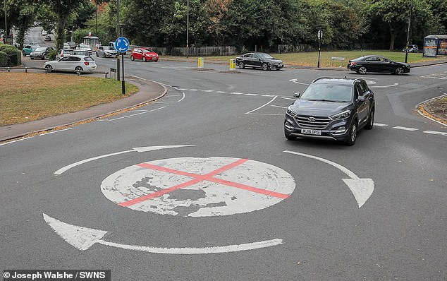 Red crosses have also been painted on mini roundabouts and signs. Pictured: An mini roundabout in Birmingham
