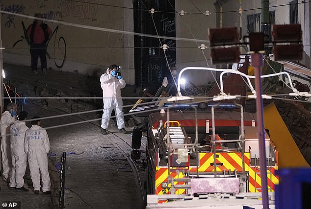 Members of the judicial police work at the site of a derailed electric streetcar in Lisbon, Portugal, Wednesday, September 3, 2025