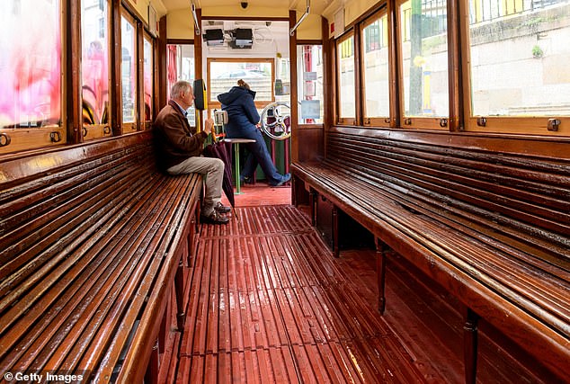 It is very popular with tourists, who use it to navigate the city's many steep hills, sitting on wooden benches without seatbelts as they chug through the historic town