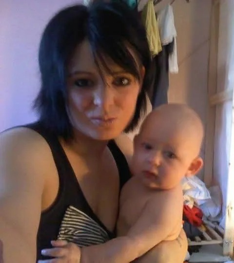 Woman holding a baby.